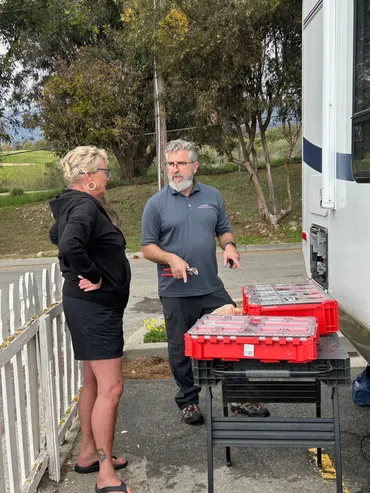 Lavender Mobile RV Solutions technician reviewing an RV repair with a customer on location