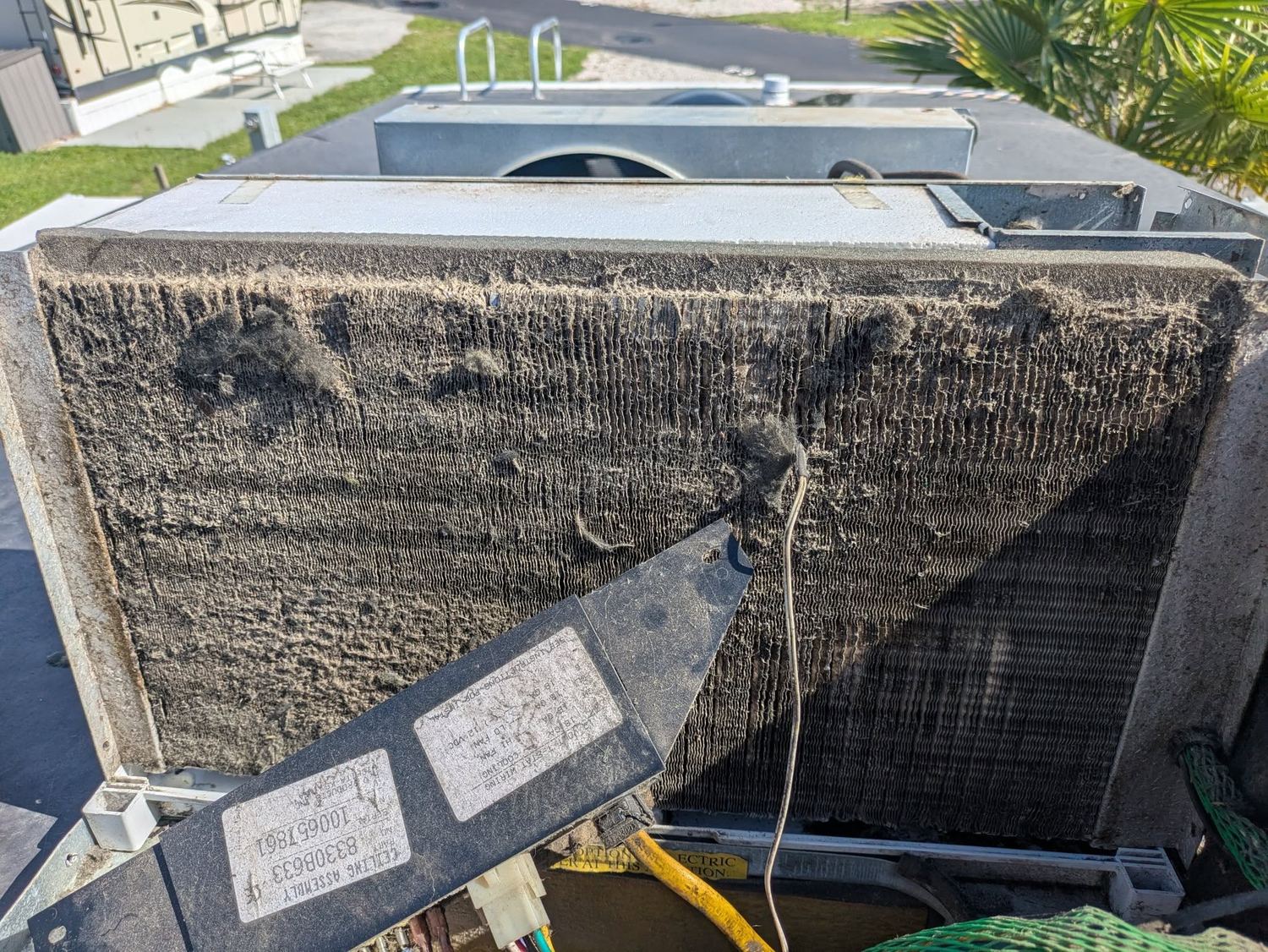 RV rooftop air conditioner with coils packed with dust and lint