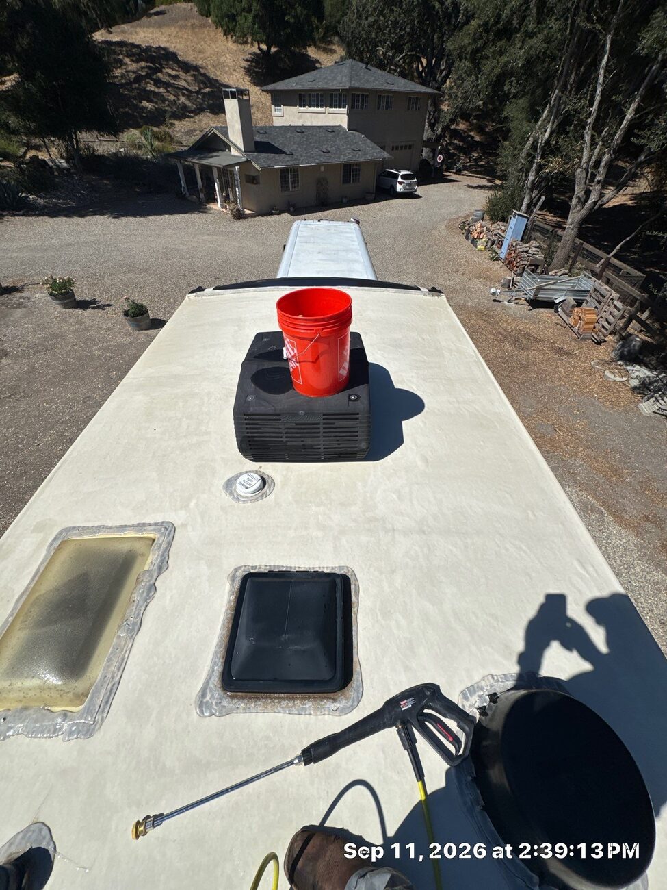 Cleaning the TPO membrane on an RV roof, half the roof already washed to bright white