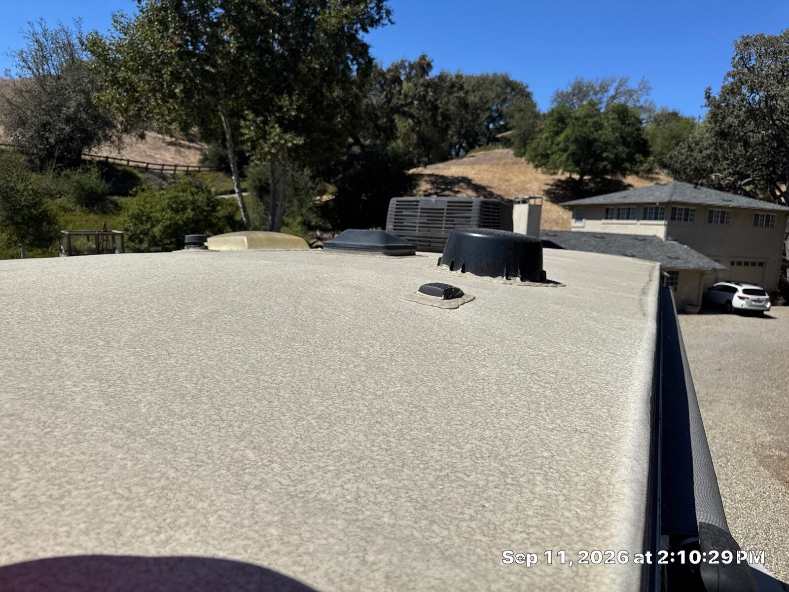 Weathered tan Alpha Systems TPO roof on a Grand Design Solitude fifth wheel in the Santa Ynez Valley before cleaning and resealing