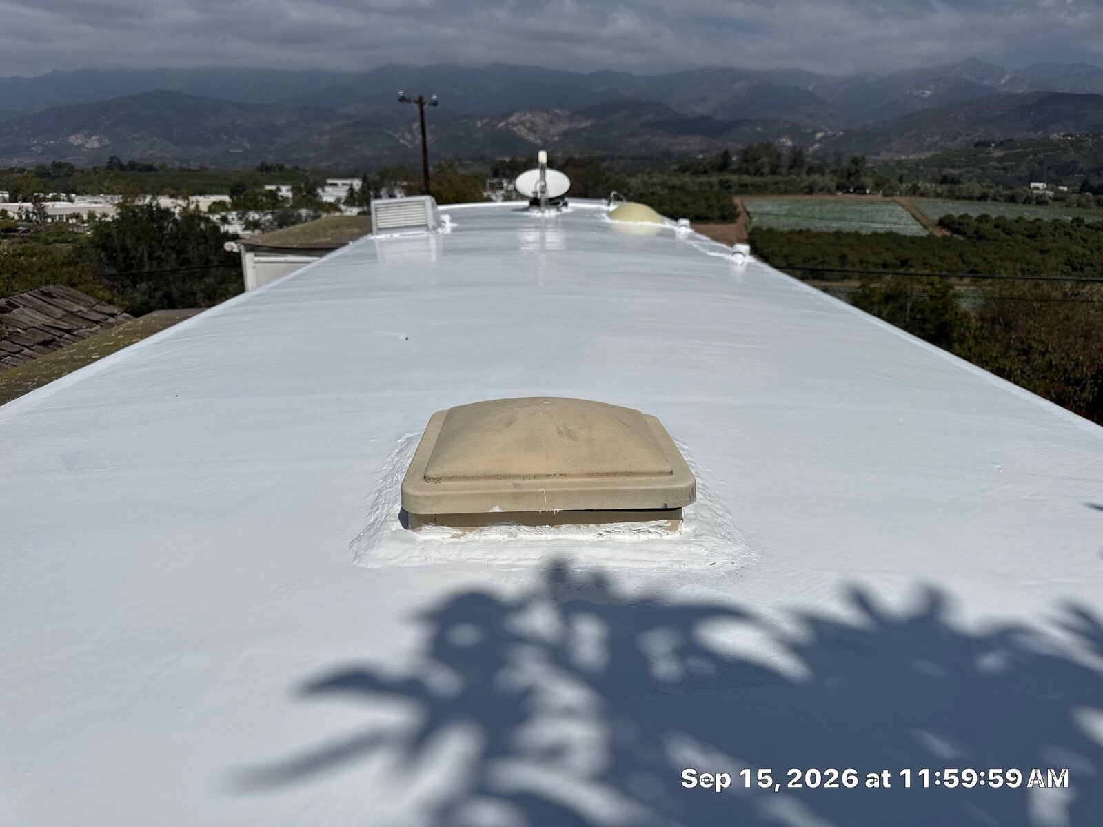 Bright white 100% silicone roof coating on a restored RV roof in Carpinteria, ready for the winter rains