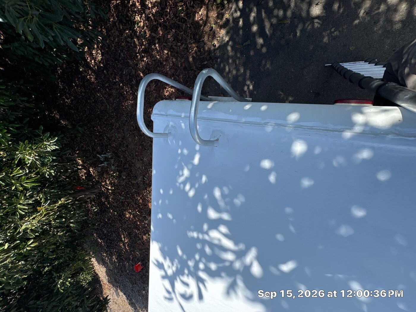 The same RV roof edge rail after cleaning and a fresh, seamless white silicone coating