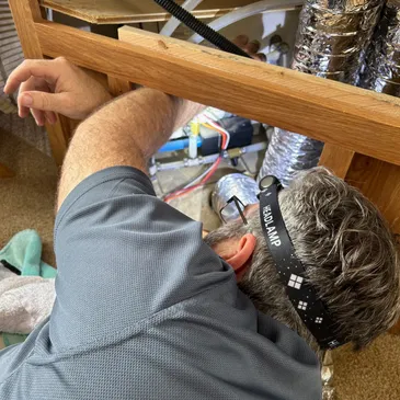 Lavender Mobile RV Solutions technician servicing an RV furnace on location